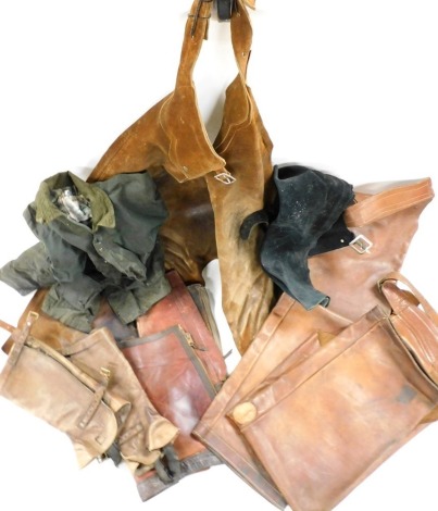 A brown leather apron, together with a pair of brown leather chaps, leg protectors, a waxed jacket, etc. (1 box)