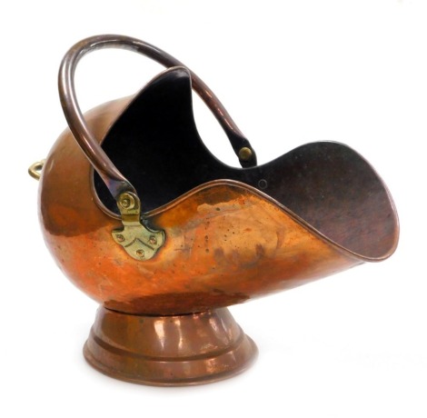 A Victorian copper helmet shaped coal scuttle, 50cm wide.