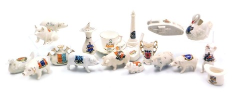 A group of Arcadian and other crested china, including pigs, a sun dial, a lighthouse, WWI tank and a top hat match striker. (qty)