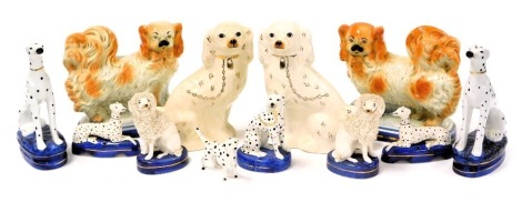 A pair of late 19thC Staffordshire figures of Pekingese, 21cm wide, together with pottery figures of poodles, dalmatians and spaniels. (qty)