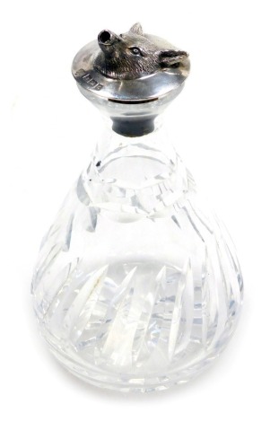 A cut glass vase or bottle, with a silver topped cork, embossed with the mask of a fox's head, Birmingham 1960.