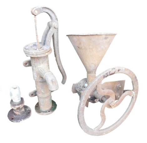 A cast iron garden water pump, 55cm high and a cast iron seed sower, 46cm high. (2)