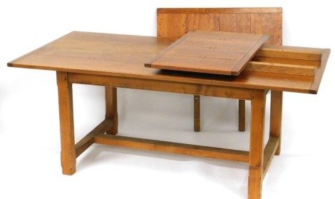 A late 20thC oak draw leaf dining table, with a four plank top, raised on canted square legs united a H frame stretcher, 73cm wide, 183cm long, 291cm extended, 92cm deep.