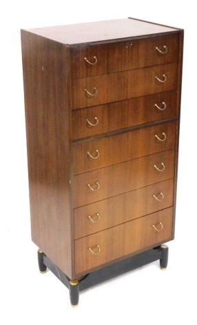 A mid century G Plan teak chest, of seven drawers, raised on a brass capped ebonised box base, 126cm high, 61cm wide, 41cm deep.