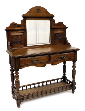 A Victorian oak mirror back washstand, by Miller and Sons, the back inset with square bevelled glass, flanked by carved panels of vines, over two friezes, raised on turned and fluted supports united by a rectangular galleried undertier, impressed marks to