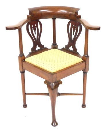 A late Victorian mahogany corner elbow chair, with a drop in seat, raised on a front cabriole leg, and three further turned legs, united by a X framed stretcher, 68cm wide.