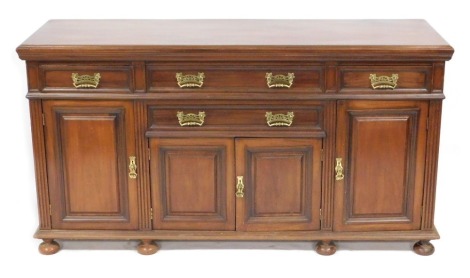 A Victorian mahogany sideboard, by James Schoolbred & Company, with two long drawers flanked by two short drawers, over two short and four tall cupboard doors, raised on bun feet, impressed marks to drawers, 97cm high, 183cm wide, 57cm deep.