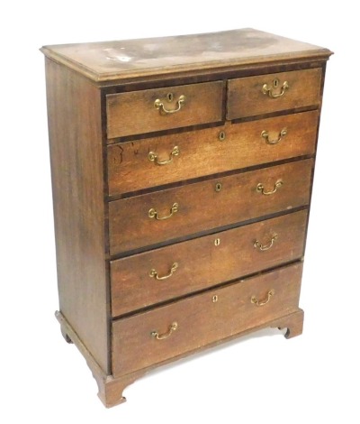 A George III mahogany and oak chest, of two short over three long graduated drawers, raised on bracket feet, 130cm high, 97cm wide, 53cm deep.