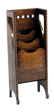 An early 20thC oak newspaper and magazine rack, of waterfall form, 97cm high, 37cm wide, 24.5cm deep.