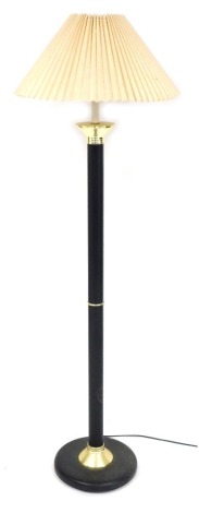 A black metal and brass capped standard lamp, with a frilled fabric shade, 149cm high.