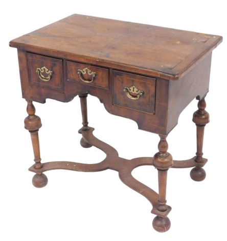 A late 18thC walnut lowboy, the rounded top raised above three frieze drawers, on turned legs, terminating in cupped bun feet, joined by an elaborate X stretcher, with an upper cross banding, 76cm high, 78cm wide, 51cm deep. (AF)