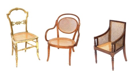 A 19thC mahogany child's chair, from James Shoolbred & Company, Tottenham Court Road, London, with a cane seat, sides and backs, raised on turned legs, 38cm wide, a 19thC gilt wood bedroom chair with a cane seat, and a Thonet Bentwood nursing chair, with 