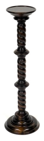 A Victorian style oak jardiniere stand, with a circular top and spiral fluted column, raised on a stepped circular base, 96cm high.