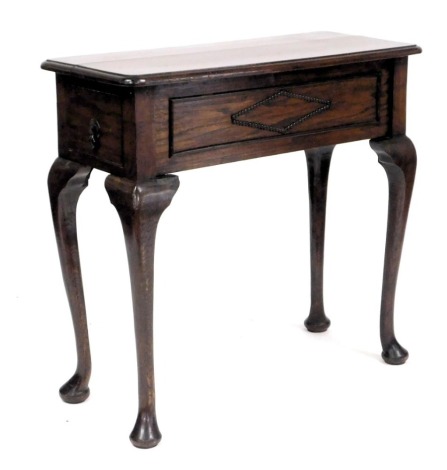 A Victorian oak side table, with a side frieze drawer, raised on cabriole legs, 80cm high, 85cm wide, 37cm deep.