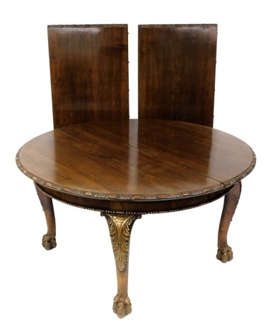 A Victorian mahogany and parcel gilt draw leaf dining table, with two additional leaves, raised on leaf carved cabriole legs and paw feet, 74cm high, 140cm wide, 260cm extended, 140cm deep.