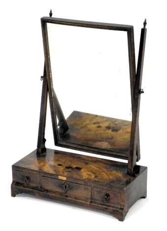 A Georgian style mahogany swing frame toilet mirror, the mirror with a rectangular plate, raised on a base with one long and two short drawers, 60cm high, 41.5cm wide.