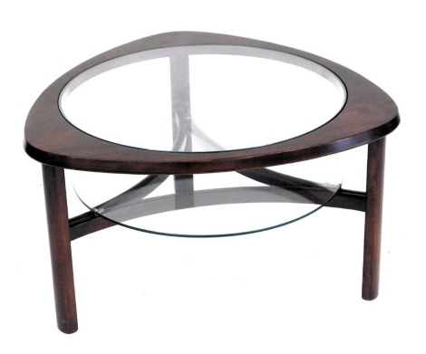 A mid century teak coffee table, possibly Scandinavian, the curved three sided top inset centrally with a circular glass plate, raised on turned legs united by stretchers, topped with a further glass plate, 43.5cm high, 76cm diameter.