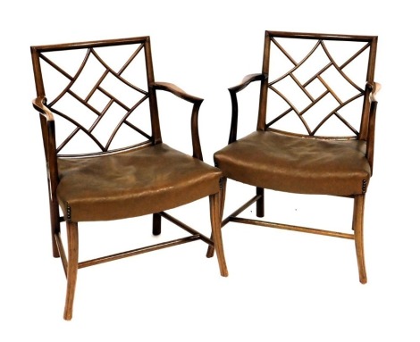 A pair of early 20thC Chinese Chippendale style mahogany carver chairs, with brown leatherette seats, 56cm wide.