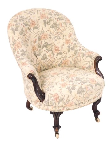 A Victorian mahogany spoon back armchair, upholstered in floral cream button back fabric, raised on cabriole legs, brass capped, on ceramic castors, 74cm wide. (AF)