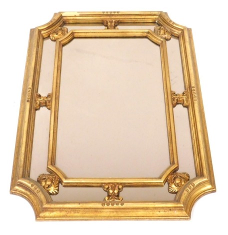 A Regency style gilt wood and gesso rectangular wall mirror, with canted corners, 96.5cm high, 70.5cm wide.