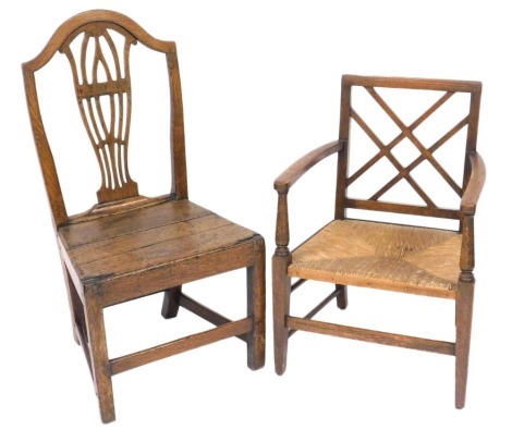 A George III oak country chair, with a carved vase shaped splat, solid seat, raised on square legs united by stretchers, and an early 19thC oak carver chair with a rush seat, raised on tapering square legs. (2)