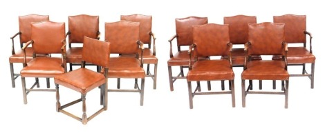 A set of ten oak carver chairs, with tan leather seats and backs, and a further chair, similarly upholstered. (11)