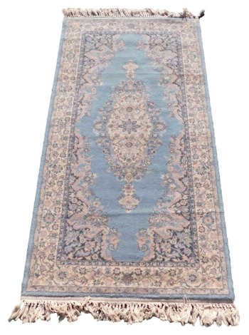 A Belgian Super Keshan blue ground rug, 162cm x 84cm.