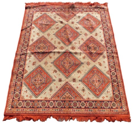 A caucasian cream ground rug, the central field decorated with floral medallions, within repeating floral borders, 164cm x 130cm.