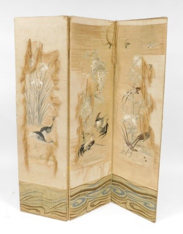 A late 19thC Chinese silk three fold screen, decorated with grebes and irises, fighting cocks and wisteria, pheasants and flowers, and butterflies, 169cm high, 135cm wide. (AF)