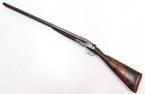 A 12 bore side by side shotgun, maker unknown, with a walnut stock, 110cm long. NB. A current valid Shotgun Certificate is required to view and bid on this lot.