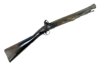 An 18thC flintlock blunderbuss by Barnett of London, with brass barrel, steel ram rod, brass trigger guard and furniture, stamped Barnett London, walnut stock, 87cm long overall.