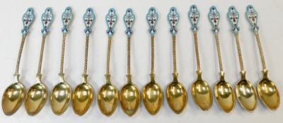 A set of twelve early 20thC Russian silver gilt and enamel coffee spoons, each with a shaped top, on twist stem with cream and blue floral enamel back, white metal stamped 88 fineness, 6oz. - 2