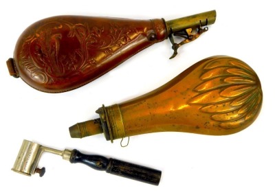 Two 19thC powder flasks, comprising a copper and brass powder flask, 20cm, a leather and brass powder flask with embossed decoration depicting pheasant, flowers, etc., 22cm, and a Schultze gun powder measure, with ebonised wooden handle, 14.5cm long.