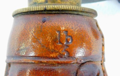 Two 19thC powder flasks, comprising a copper and brass powder flask, 20cm, a leather and brass powder flask with embossed decoration depicting pheasant, flowers, etc., 22cm, and a Schultze gun powder measure, with ebonised wooden handle, 14.5cm long. - 5