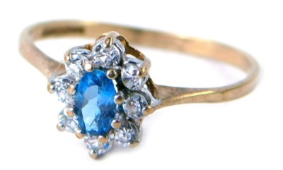 A 9ct gold cluster ring, the central stone set with an oval pale blue stone surrounded by CZ, each in claw setting, ring size O½, 1.4g all in.