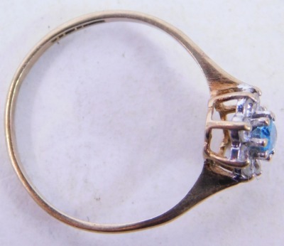 A 9ct gold cluster ring, the central stone set with an oval pale blue stone surrounded by CZ, each in claw setting, ring size O½, 1.4g all in. - 2