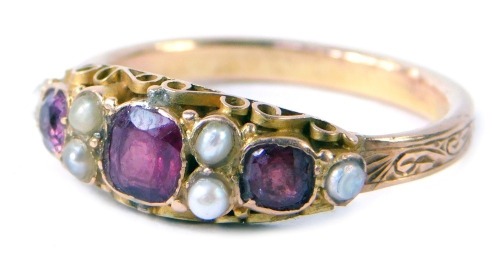 A ruby and seed pearl dress ring, set with square cut garnets and six seed pearls, ring size S, yellow metal, unmarked, 3.5g all in.