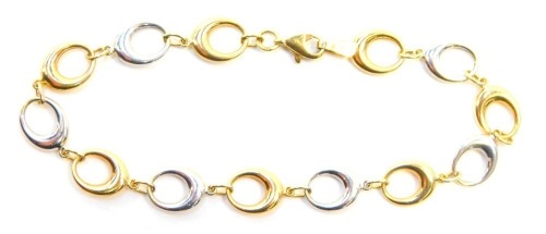 A bicolour modern bracelet, each link in white or yellow gold, yellow metal stamped 375, 18cm long, 3.1g. (no signs of repair evident)