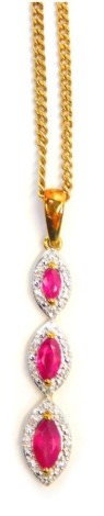 A 9ct gold ruby and diamond pendant and chain, the layered rubies of marquise shaped design, centred by ruby and halo of diamonds, the pendant 3cm high, on fine link neck chain, 44cm long, 3.7g all in.