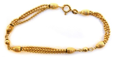 A 9ct gold fancy link bracelet, with three chain link design, and rubbed and hammered links in the Eastern links, 18cm long, 6.8g.