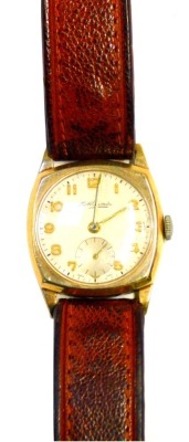 A Thomas Russellworth 9ct gold cased gentleman's wristwatch, the silvered numeric dial with gold hands and seconds dial, on a brown leather strap, 3cm wide, 22.4g all in.