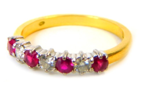 An 18ct gold, ruby and diamond half hoop dress ring, set with four round brilliant cut rubies and three round brilliant cut diamonds, each in platinum setting, on a yellow metal band, ring size O½, 2.9g all in.