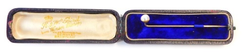 A cultured pearl stick pin, the single cream finish pearl, on a yellow metal frame, unmarked believed to be 9ct, 6cm long, in R&W Bird of Grantham box.