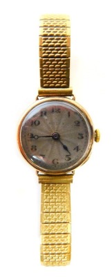 A Rolex 9ct gold cased lady's wristwatch, with a circular silvered numeric dial, in a 9ct gold case, with Rolex Prima fifteen jewel movement, 2cm diameter, on an expanding stainless steel and plated strap, 25.4g all in.