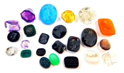 A group of semi precious stone seals, to include citrine, rock crystal and others, some bearing faces others bearing mottos. (a quantity)