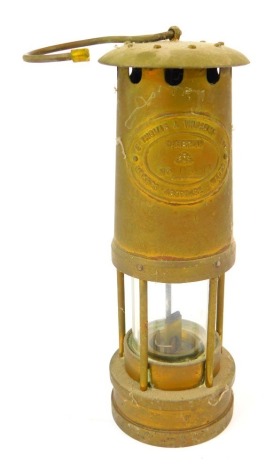 An E Thomas and Williams Ltd Cambrian brass miner's lamp, number 109943, with swing handle, 26cm high.