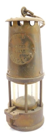 A M.R.S. Shipley Newstead Colliery brass military miner's lamp, with swing handle, 25.5cm high.