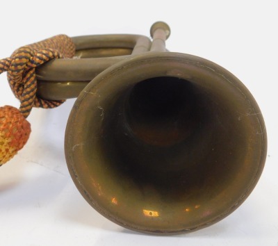 A copper and brass bugle, with orange, yellow and blue rope work frogging, 29cm long. - 2