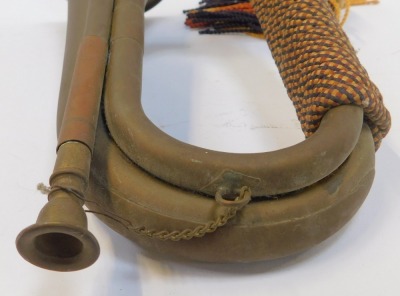 A copper and brass bugle, with orange, yellow and blue rope work frogging, 29cm long. - 3