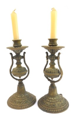 A pair of Victorian brass gimbal ship's wall mounted candle holders, each embossed with scrolls, repeat decoration, etc., 25cm high.